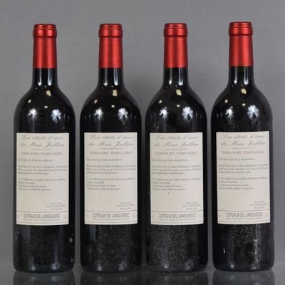 three bottles of wine are lined up on a table