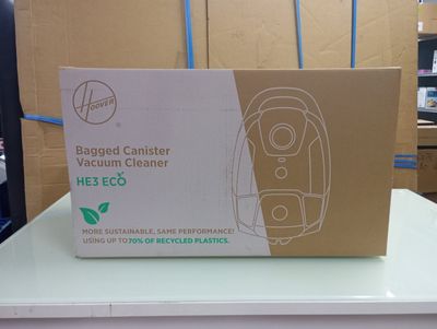 a cardboard box with a vacuum cleaner on top of it