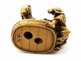 a figurine of a man on a barrel with a dog