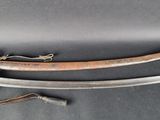 a close up of two swords on a table with a rope