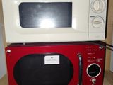 un micro-ondes rouge posé sur une étagère en bois