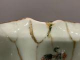 a close up of a white bowl with a bird on it