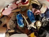 many pairs of shoes that are piled together in a pile