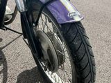 a purple motorcycle parked on the side of the road