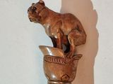 a statue of a cat sitting on top of a vase