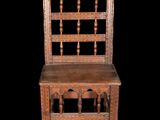 an old wooden chair with a wooden seat on a black background