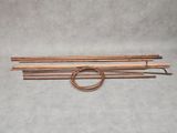a set of four copper electrodes on a grey background