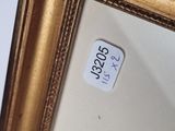 an image of a picture of a gold frame with a sticker on it