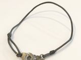 a black cord bracelet with a silver clasp on it