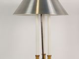 une lampe de table en laiton surmontée d'un abat-jour en verre transparent