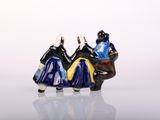 two figurines of a man and a woman riding on a horse