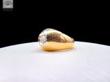 a close up of a gold and diamond ring on a white surface