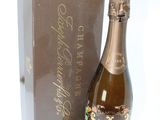 a bottle of champagne sitting next to a box