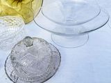 a glass bowl with a lid and a glass bowl with a lid on a table