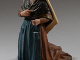 figurine représentant une femme en robe bleue, assise sur un tapis