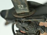 a person holding a knife with a handle in their hand