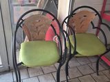 two chairs sitting next to each other on a tiled floor
