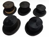 several hats are lined up on top of each other on a white surface