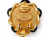 an image of a close up of a gold and black broochle