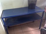 a blue table with a basket on top of it