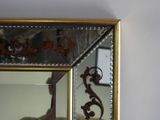 a mirror on the wall reflecting a man ' s reflection