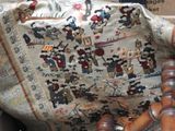 a chair that has a tapestry on the back of it