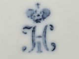 an old blue and white plate with a crown on it