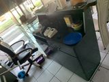 a desk with a glass top and a chair in front of it