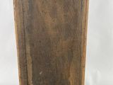 an old wooden easel with a piece of wood sticking out of it