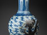 blue and white vase with a dragon on the outside of it