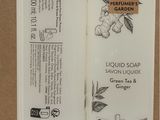 two bottles of liquid soap sitting next to each other