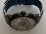 a watch that is on display on a white surface