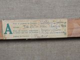 an old baseball bat with a piece of paper attached to it