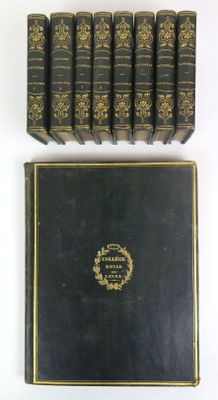six books are lined up in a row on a white surface
