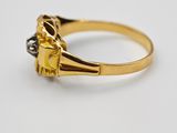 a gold and diamond ring with a single stone in the center