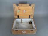 a small wooden box with a lid that has a pine cone inside of it