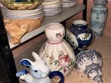 many vases and bowls on the shelves in the room