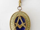 an image of a blue and gold medal with a masonic symbol on it