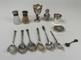a lot of spoons and salt shakers on the table