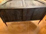 a wooden cabinet that has two doors on top of it