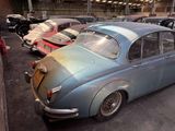 many old cars that are parked in a garage
