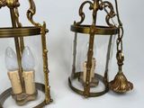 pair of antique brass and glass lanterns with candle holders
