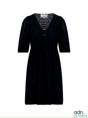 La robe est noire et comporte de la dentelle au niveau du cou.