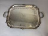 an antique silver tray with a monogram on it