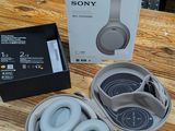 a box of headphones sitting on a table next to a pair of headphones