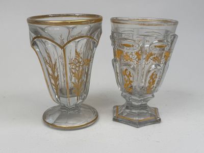 two glass vases sitting next to each other on a table