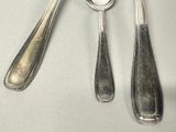 two spoons and two spoons on a table