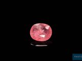 a pink diamond on a black background