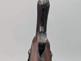 sculpture of a bird on a wooden stand with a white background