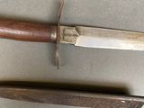 two knives that are laying side by side on a table